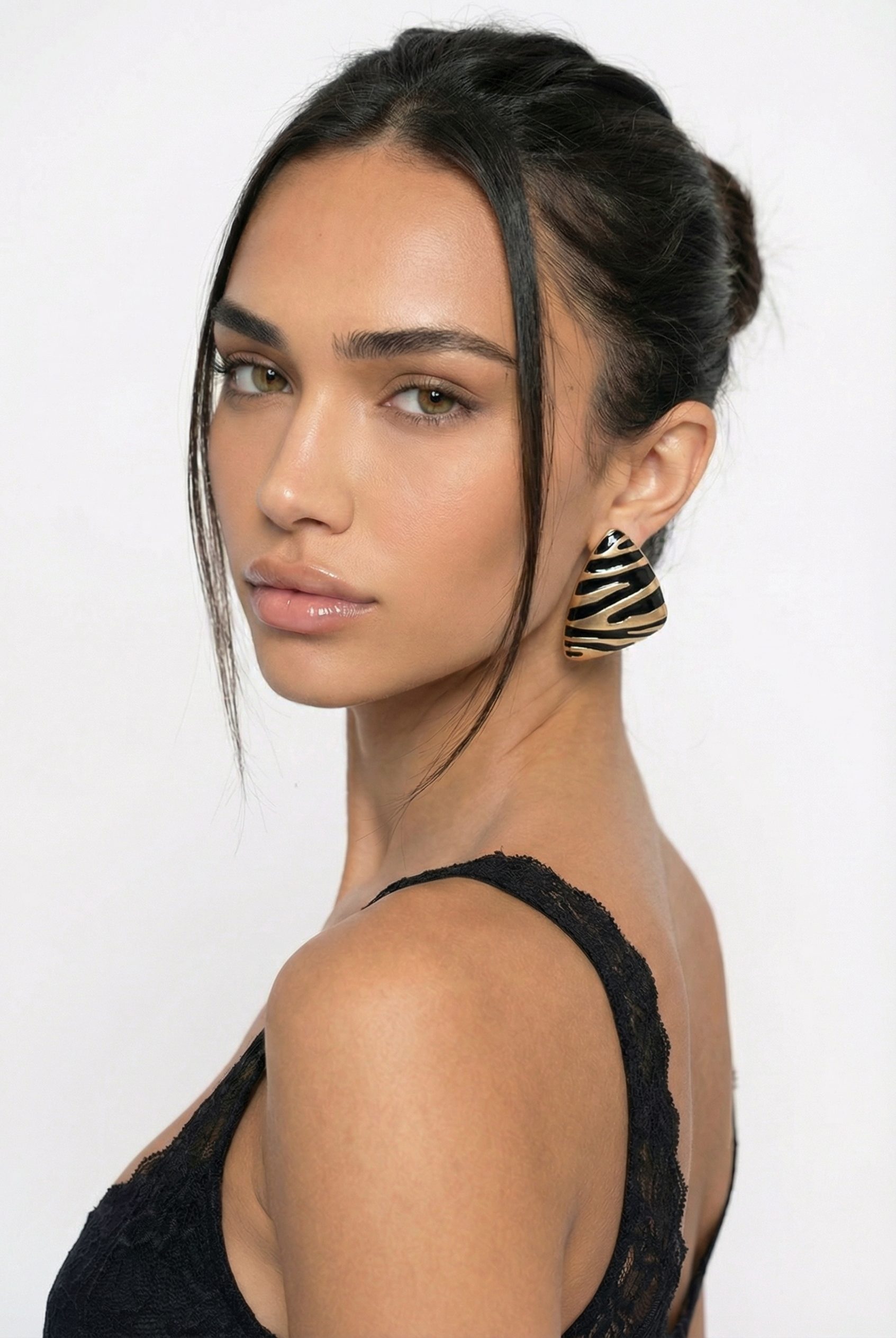Woman wearing a black top with a plain background