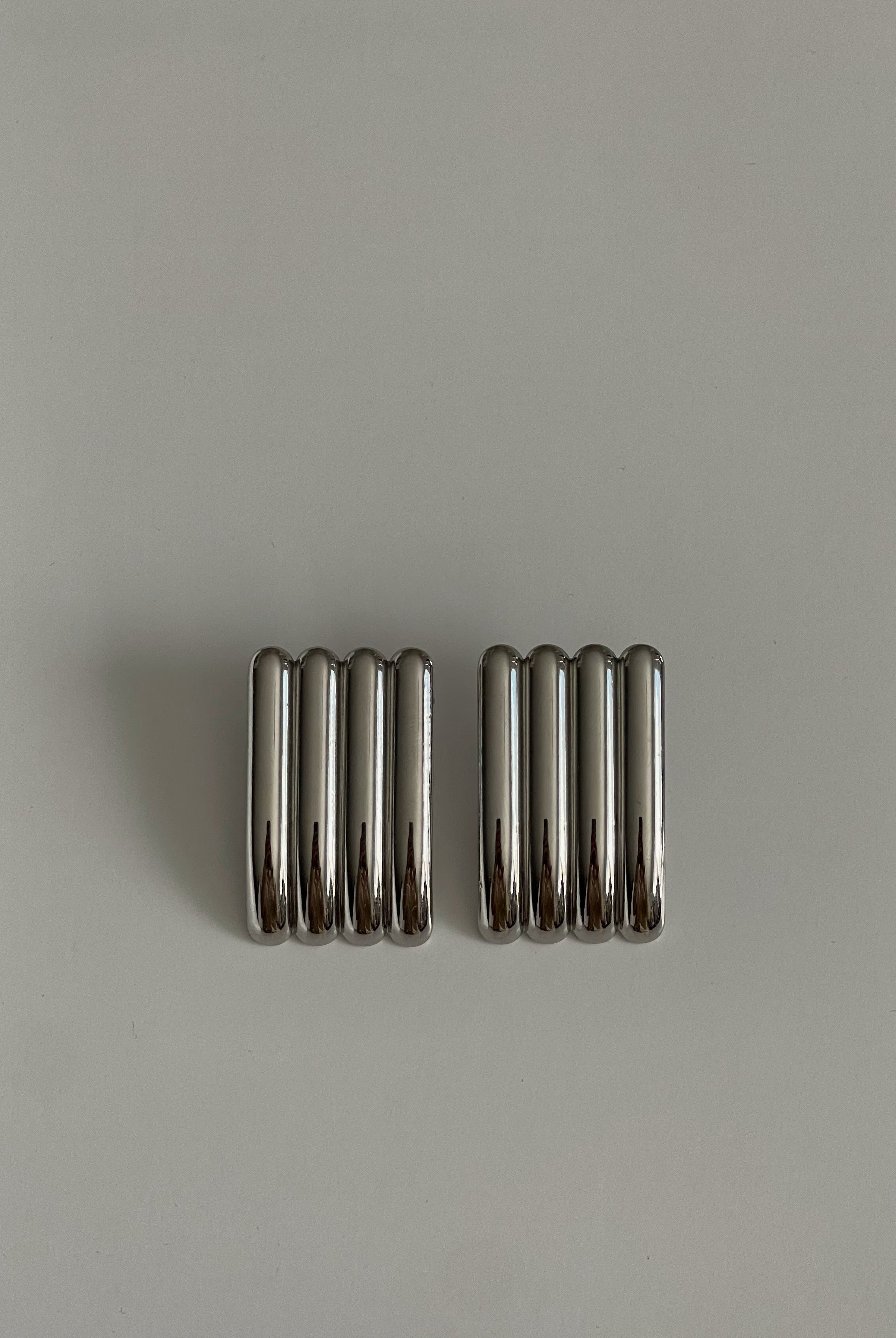 Two metallic springs on a gray background