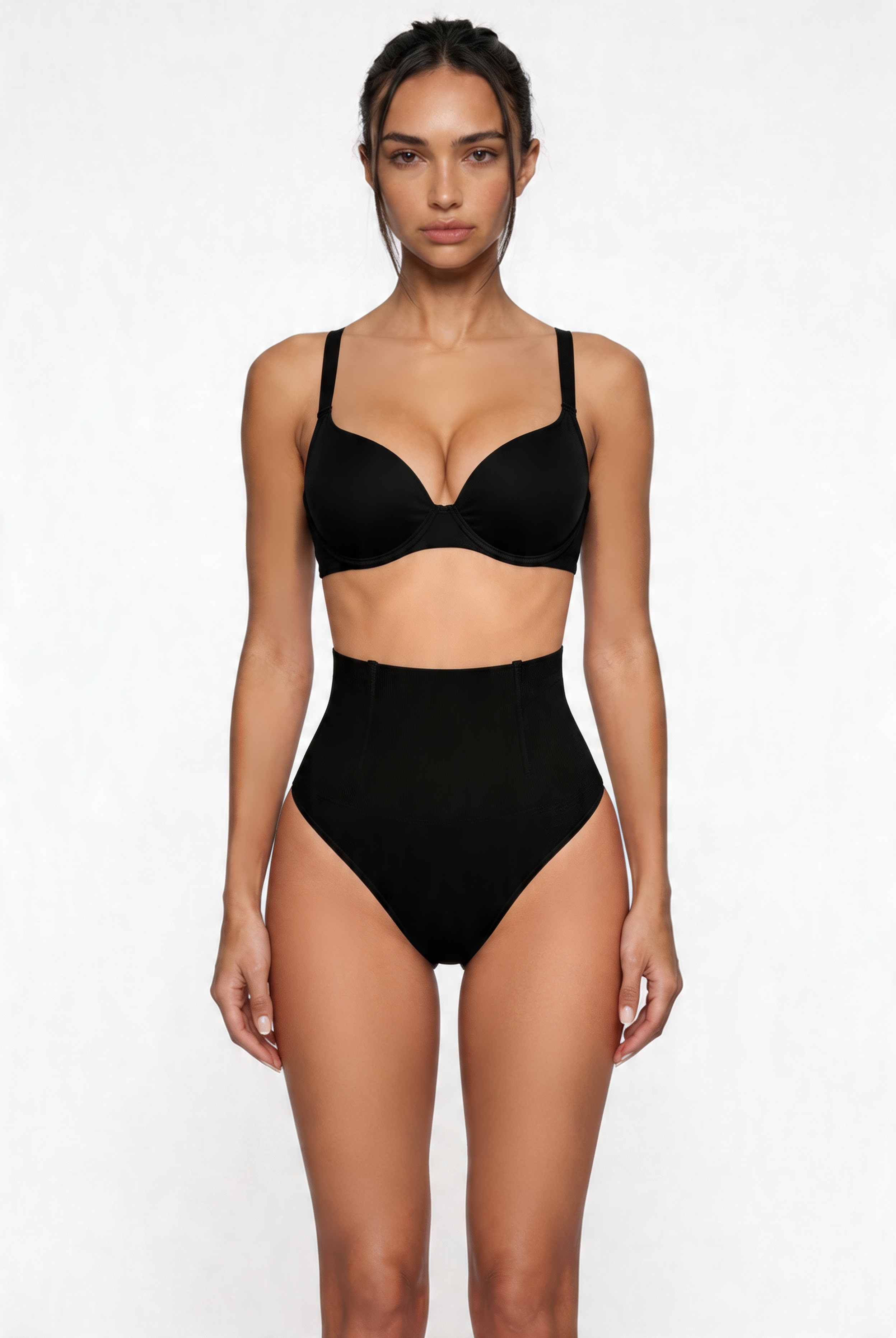 Woman wearing a black shapewear set on a white background