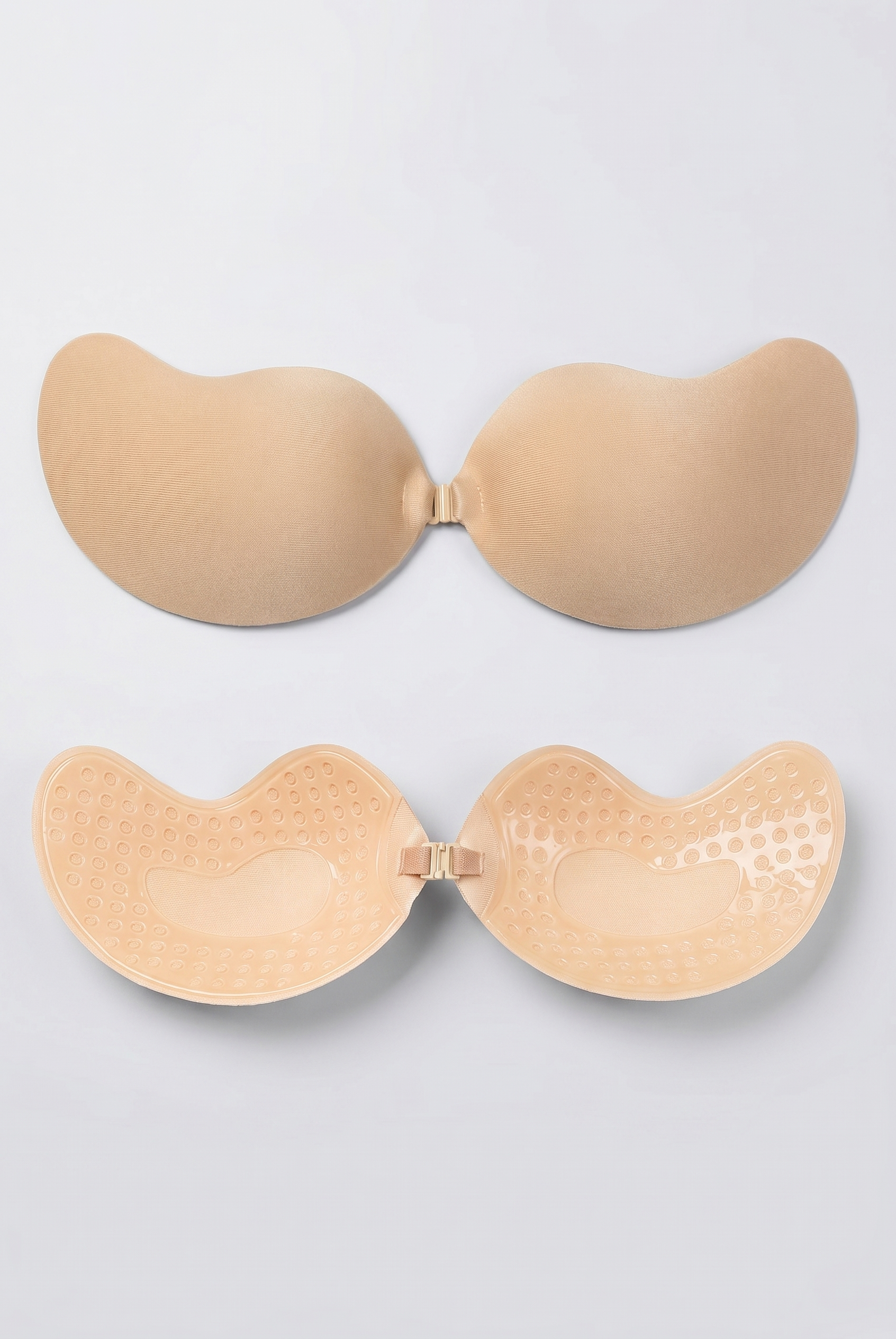 Beige adhesive bra on a light gray background