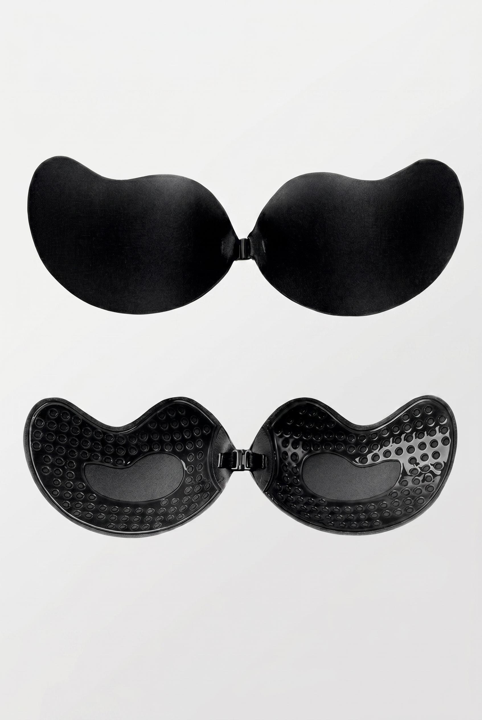 Black adhesive bra pads on a white background