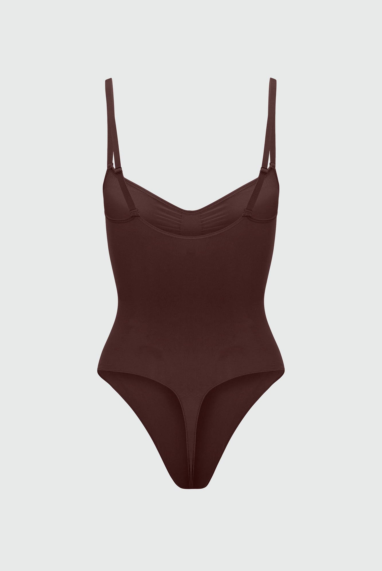 Brown bodyshaper with thin straps on a light gray background