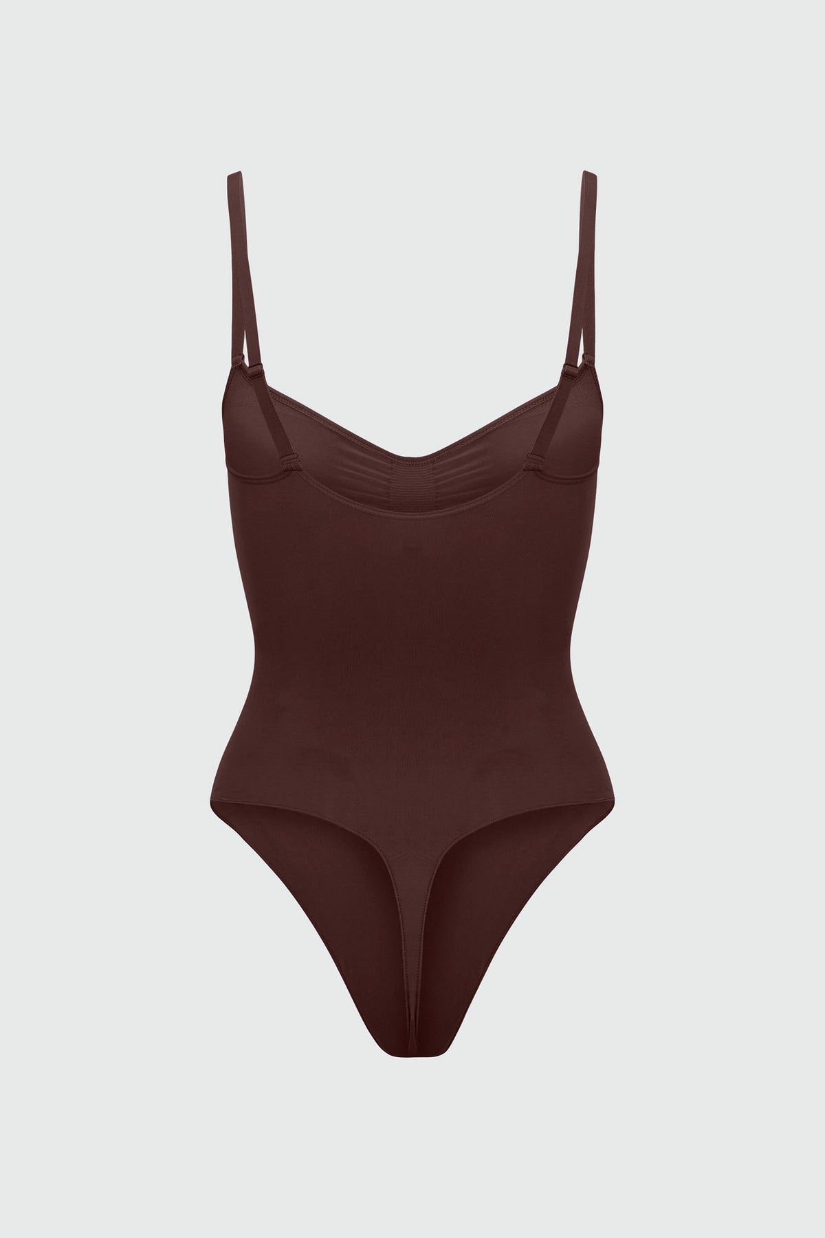 Brown bodyshaper with thin straps on a light gray background