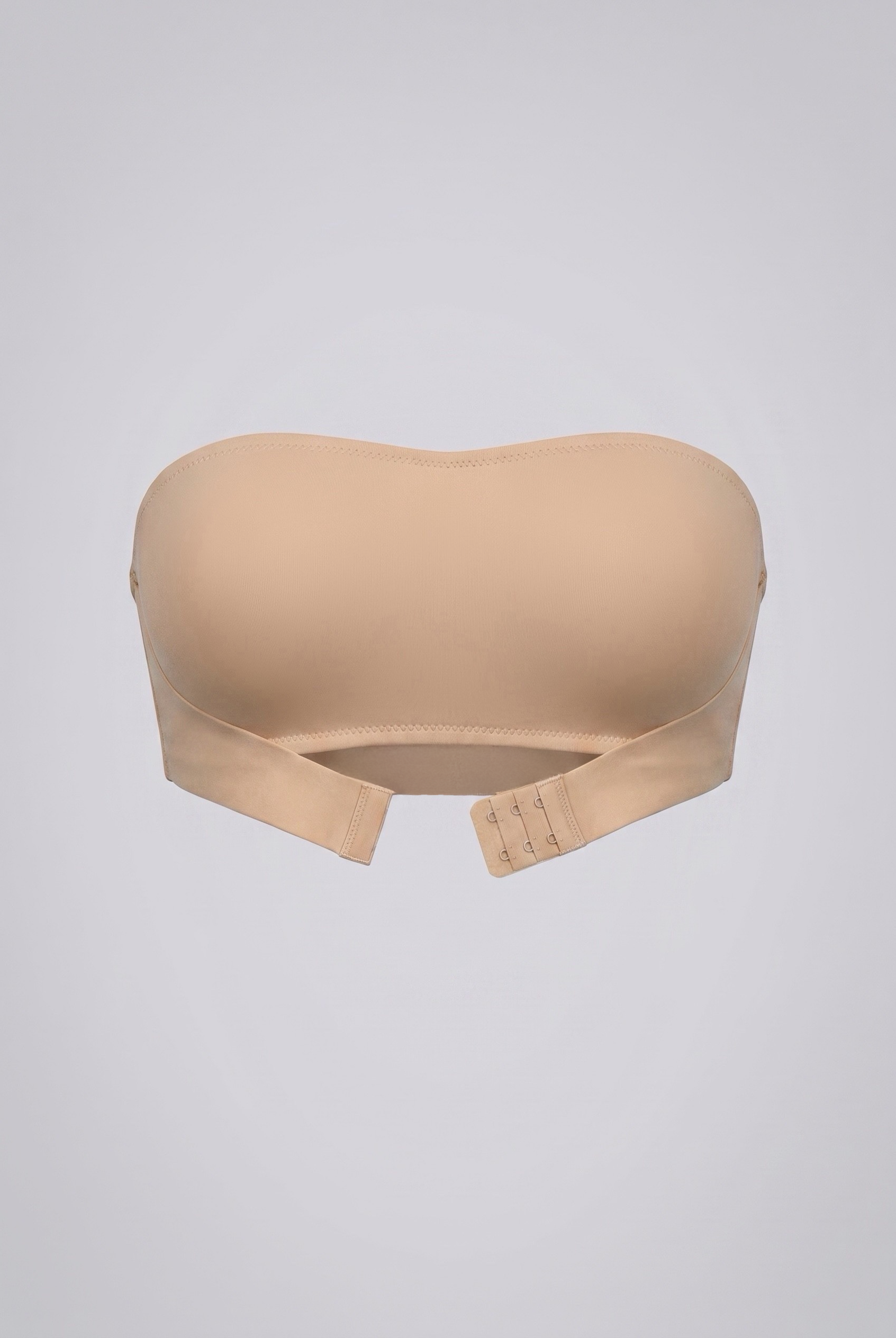 Beige strapless shapewear bra on a light gray background