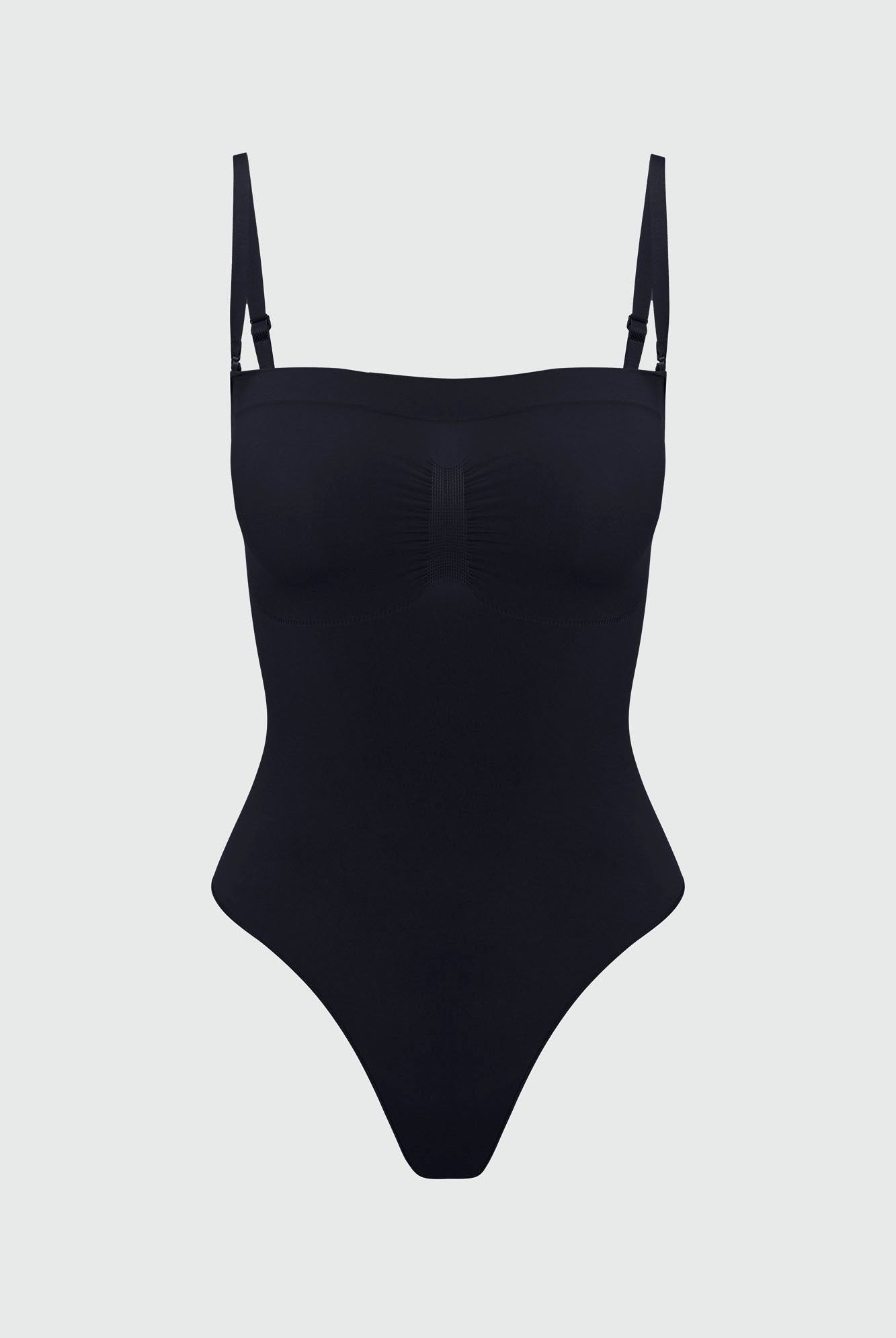 Black shapewear bodysuit with thin removable straps on a light gray background
