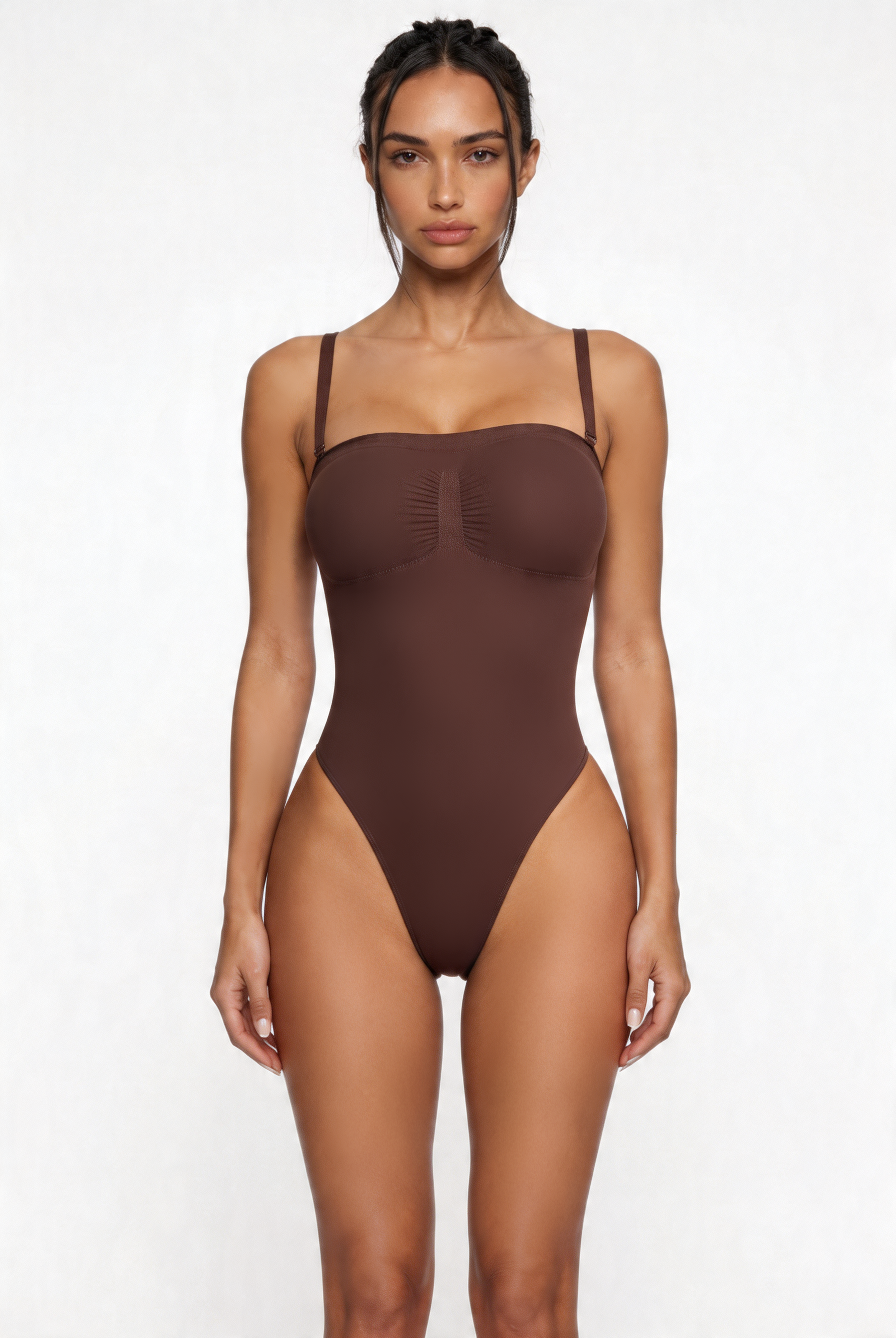 Woman wearing a brown shapewear bodysuit on a white background