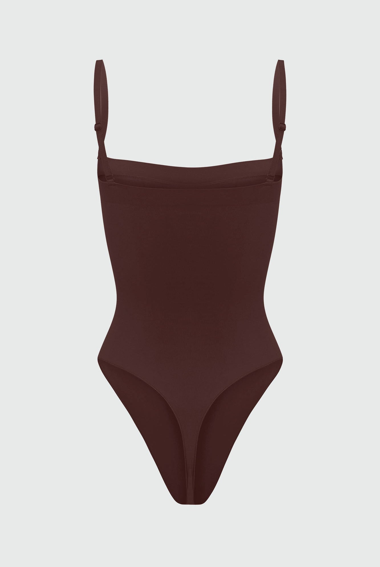 Black shapewear bodysuit with thin straps on a light gray background