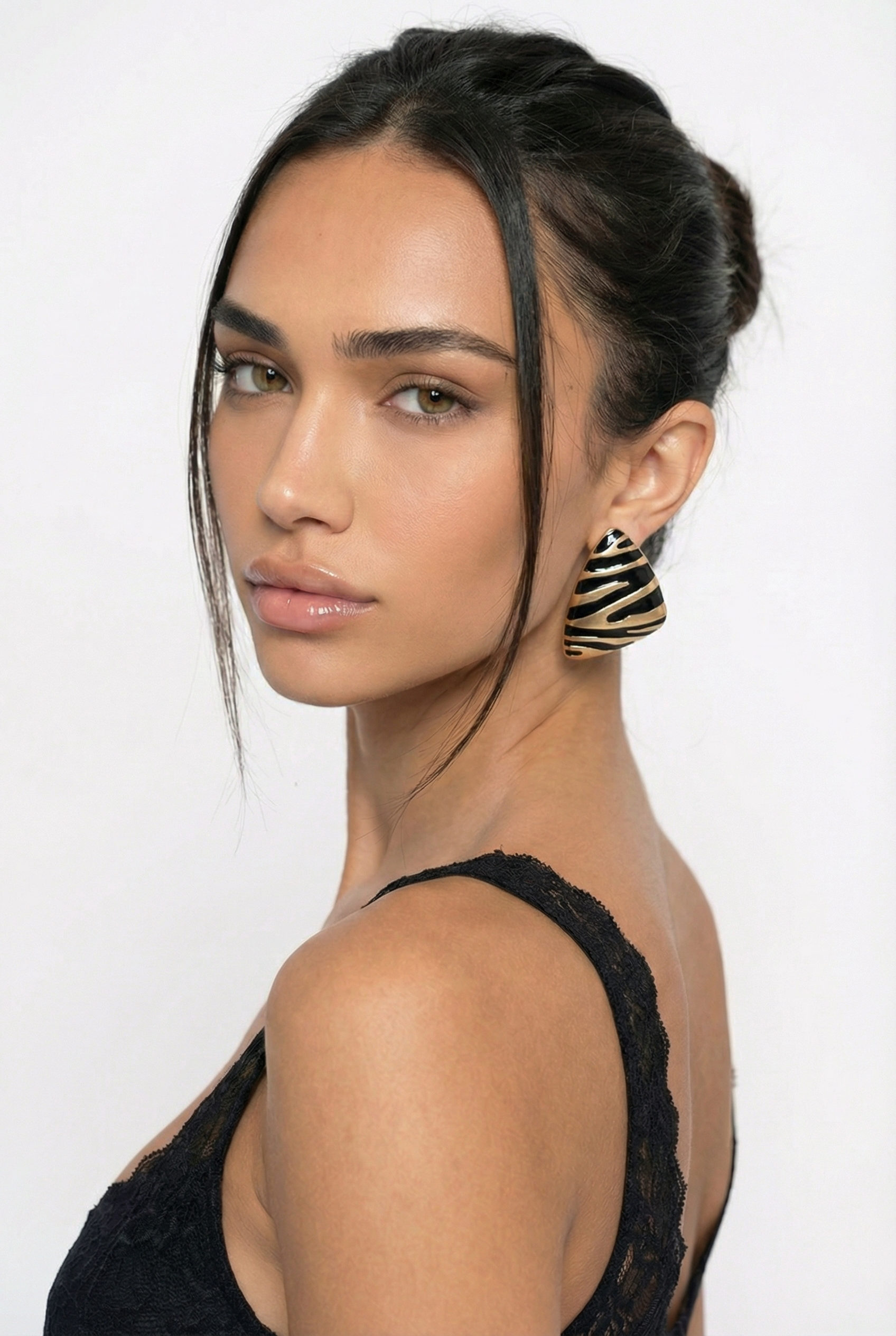 Woman wearing a black top with a plain background
