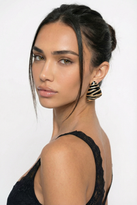 Woman wearing a black top with a plain background