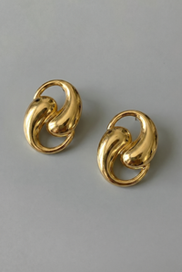 Pair of gold earrings on a gray background