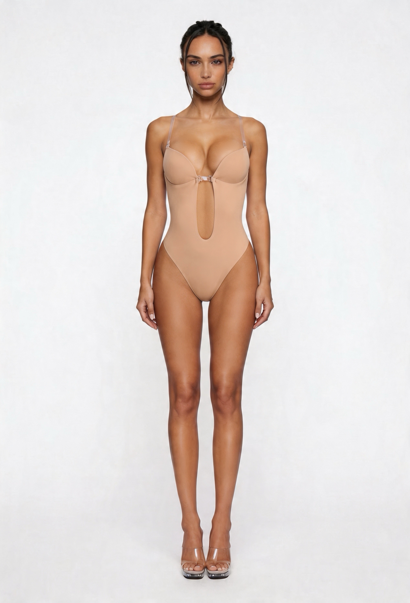 Woman wearing a beige shapewear bodysuit on a white background