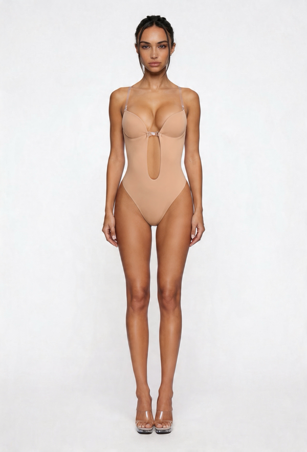 Woman wearing a beige shapewear bodysuit on a white background