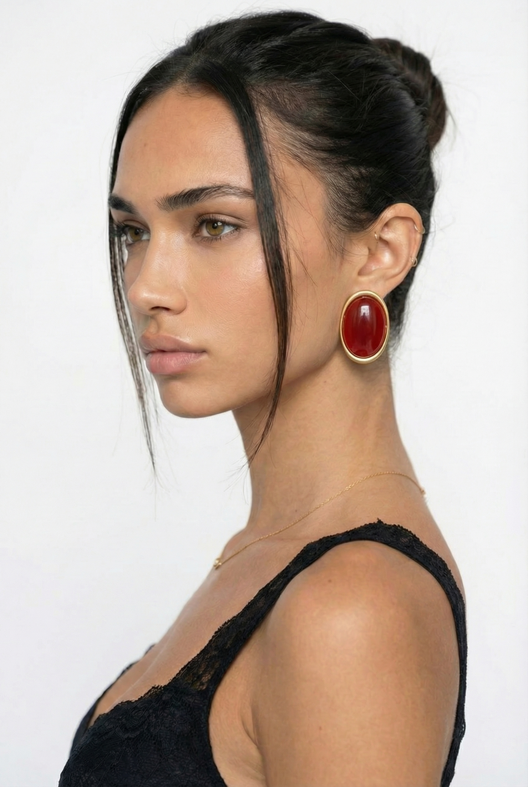 Woman wearing a black top with a plain background