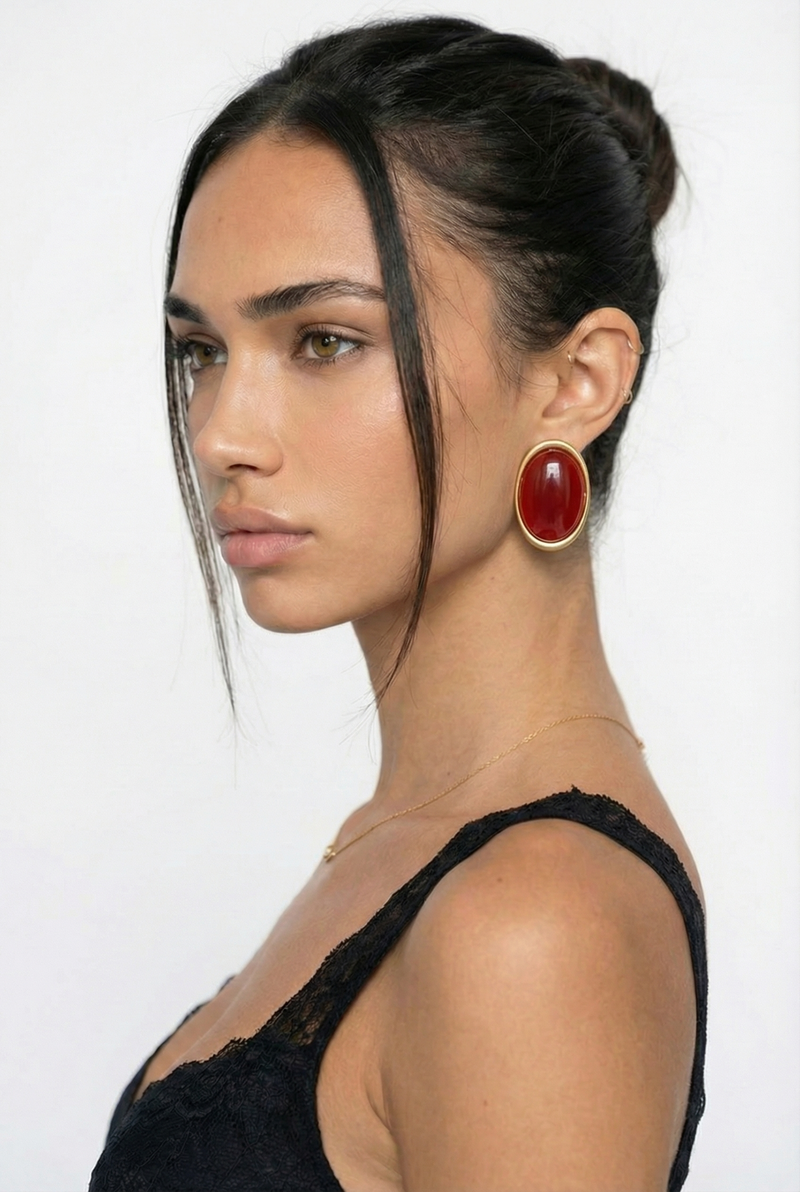 Woman wearing a black top with a plain background