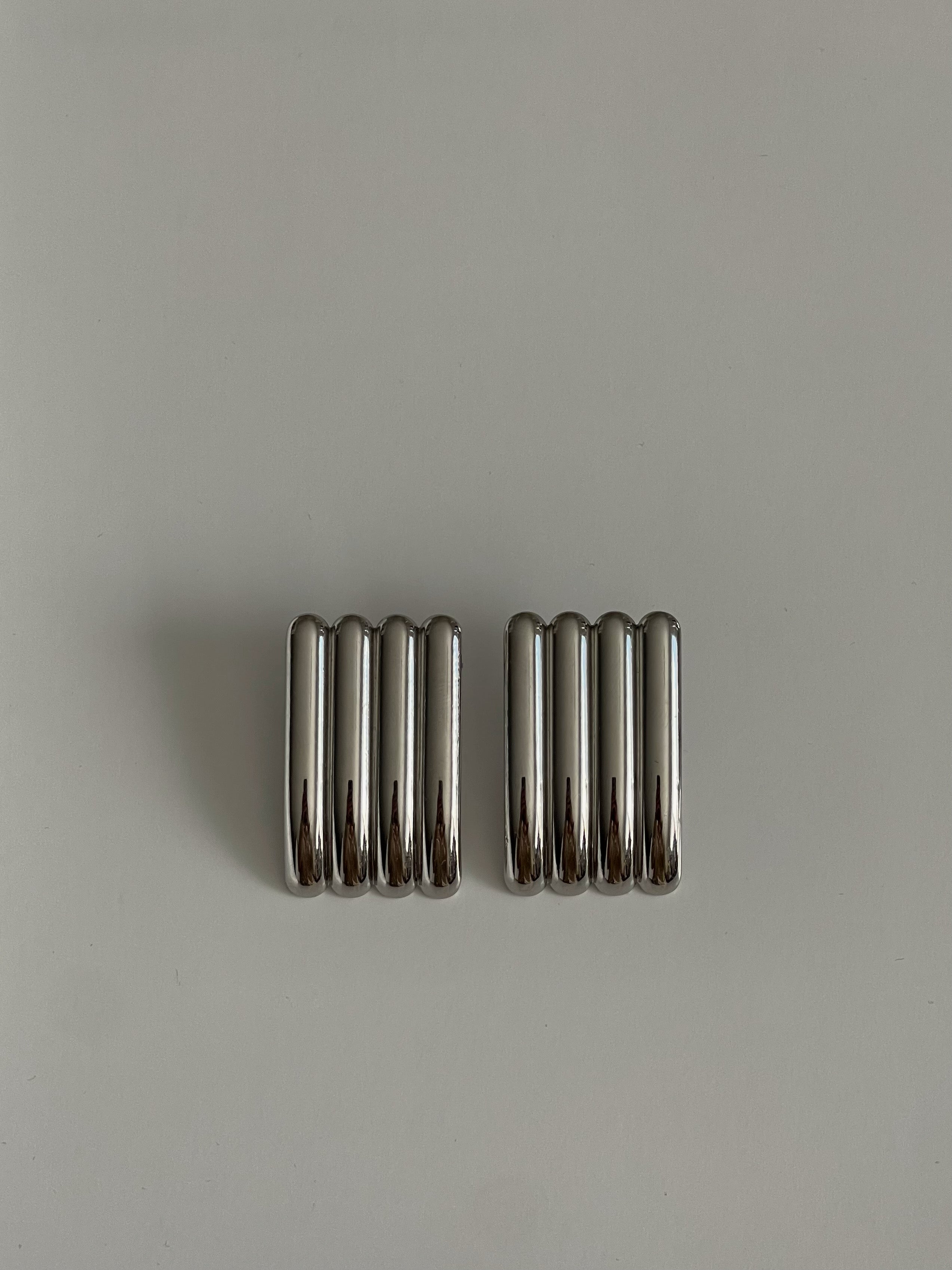 Two metallic springs on a gray background