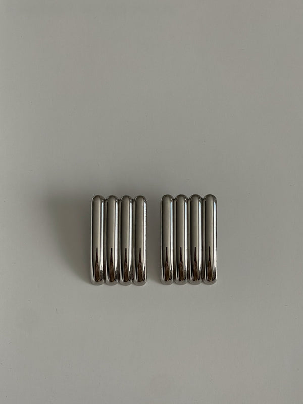Two metallic springs on a gray background