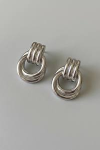 Pair of silver ring earrings on a light gray background