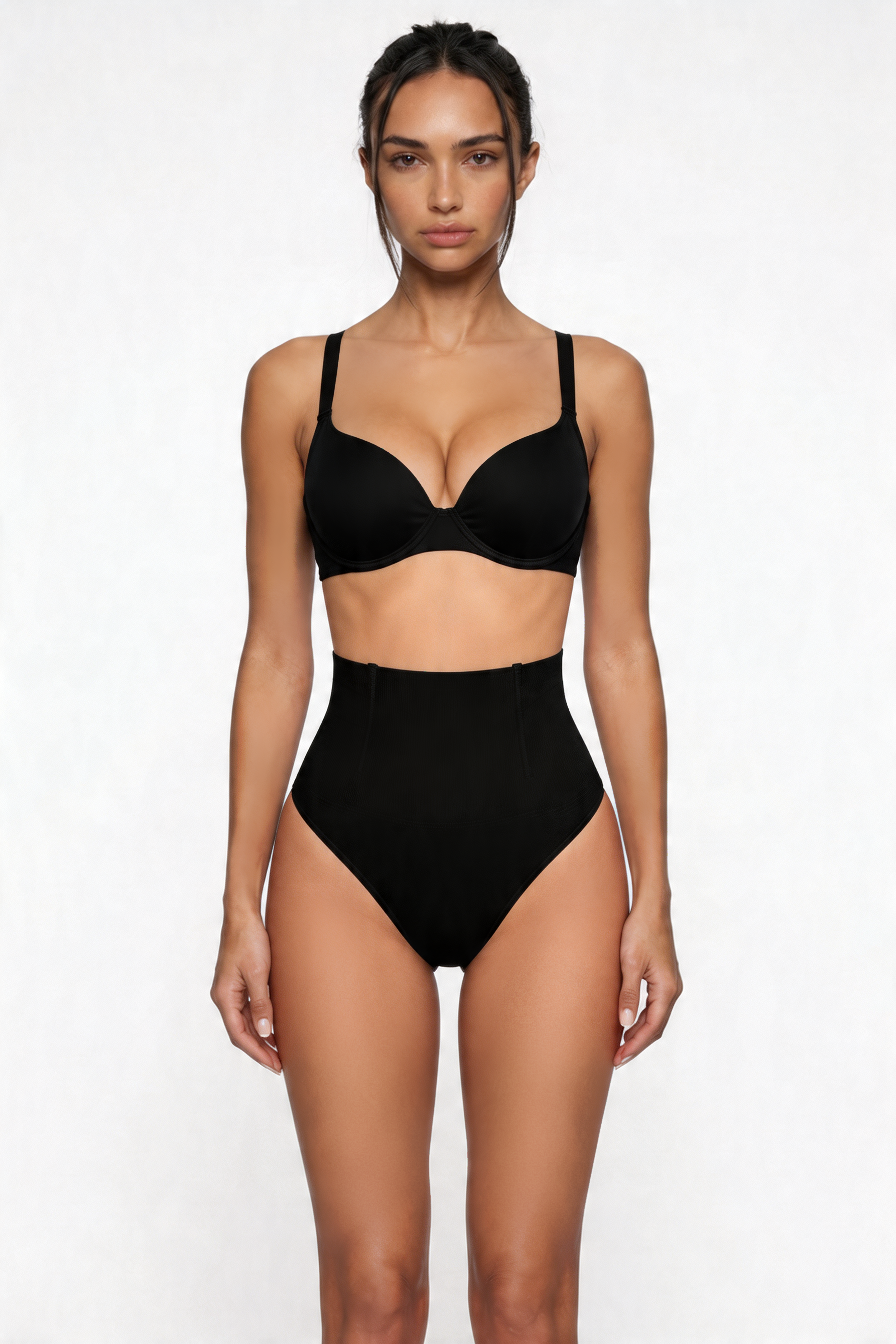 Woman wearing a black shapewear set on a white background