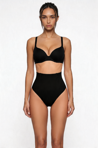 Woman wearing a black shapewear set on a white background