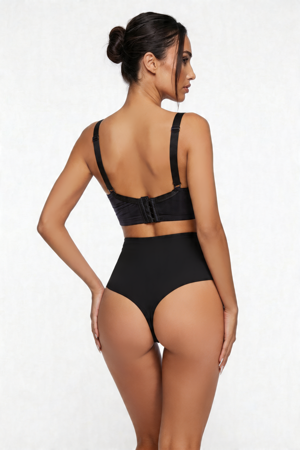 Woman wearing a black shapewear set on a white background