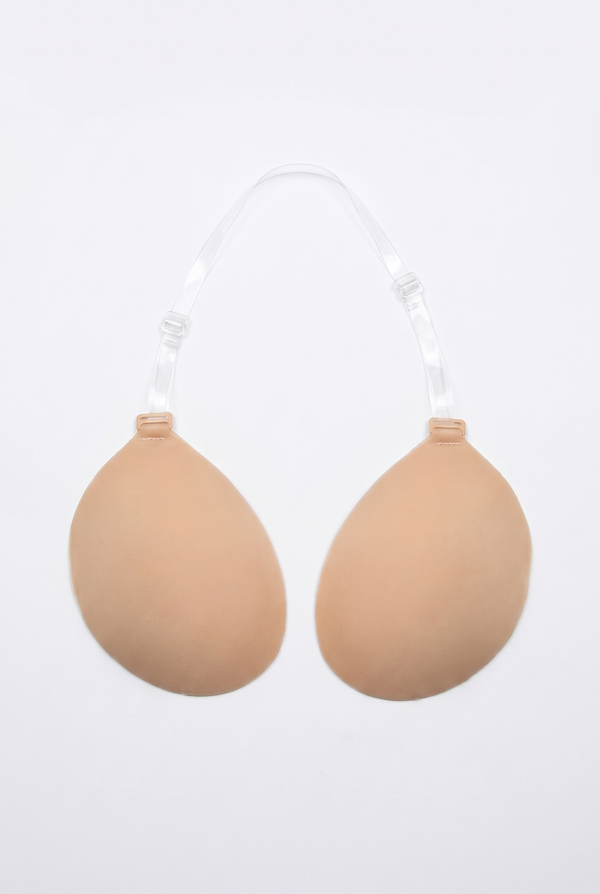 Beige breast enhancement inserts on a white background