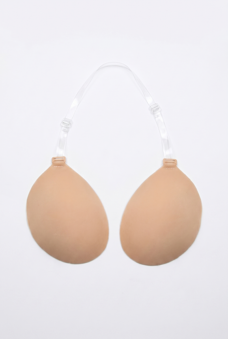 Beige breast enhancement inserts on a white background