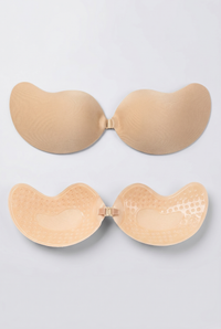 Beige adhesive bra on a light gray background