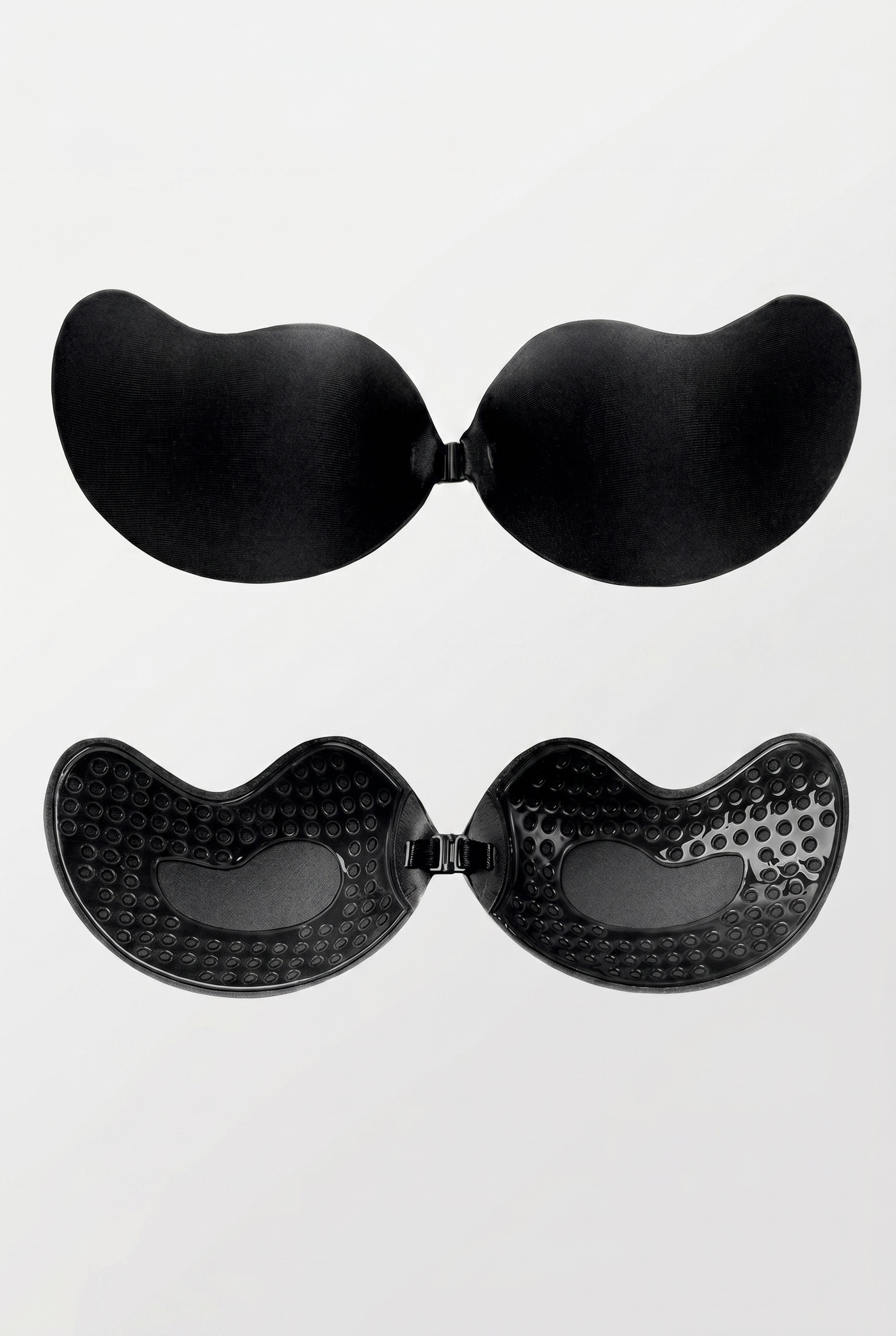 Black adhesive bra pads on a white background