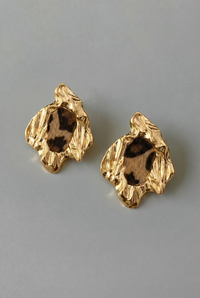 Pair of gold earrings on a gray background