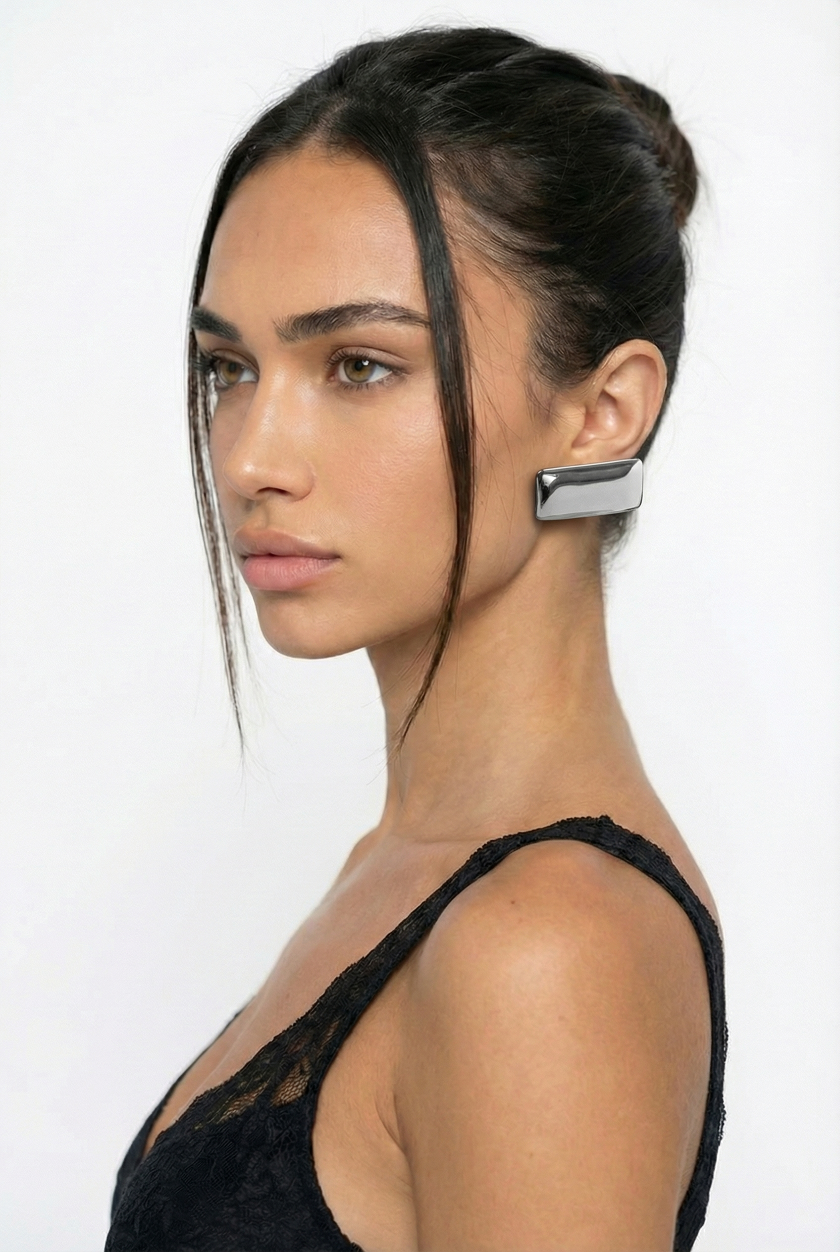 Woman wearing a unique earring on a white background
