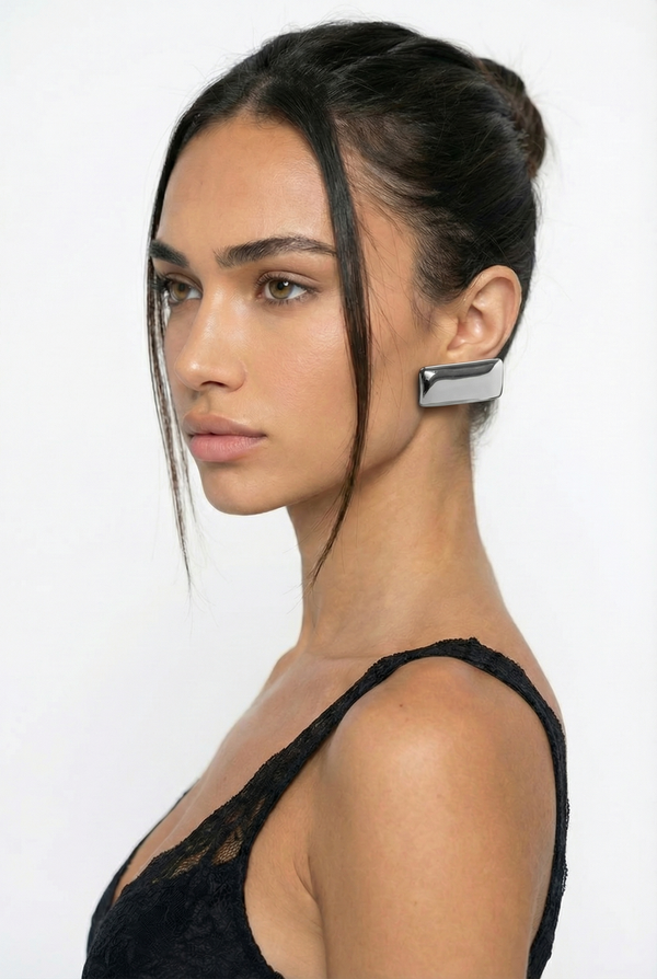 Woman wearing a unique earring on a white background