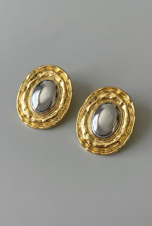 Pair of gold earrings on a gray background