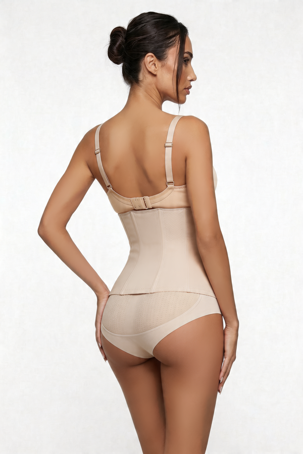 Woman wearing a beige shapewear bodysuit on a white background