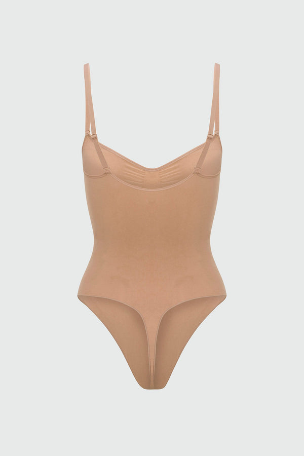Beige shapewear bodysuit with thin straps on a light gray background