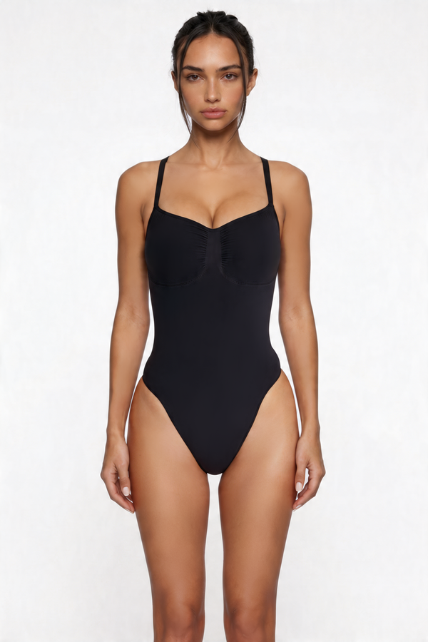 Woman wearing a black bodyshaper on a white background
