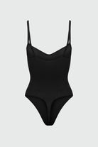 Black bodyshaper with thin straps on a light gray background