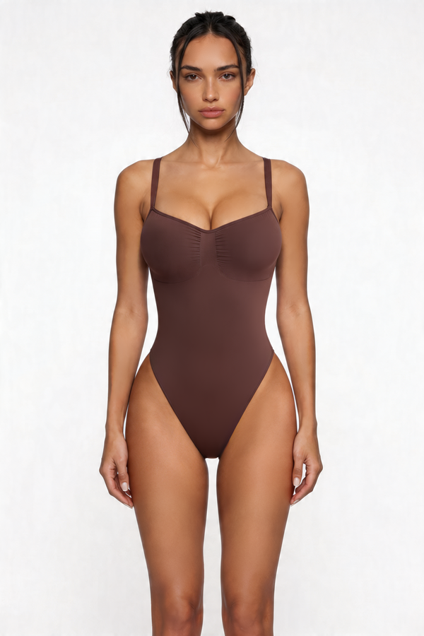 Woman wearing a brown bodyshaper against a white background
