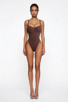 Woman wearing a brown bodyshaper on a white background