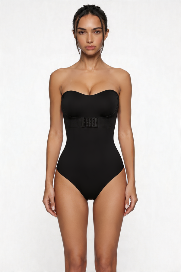 Woman wearing a black strapless shapewear bodysuit on a white background