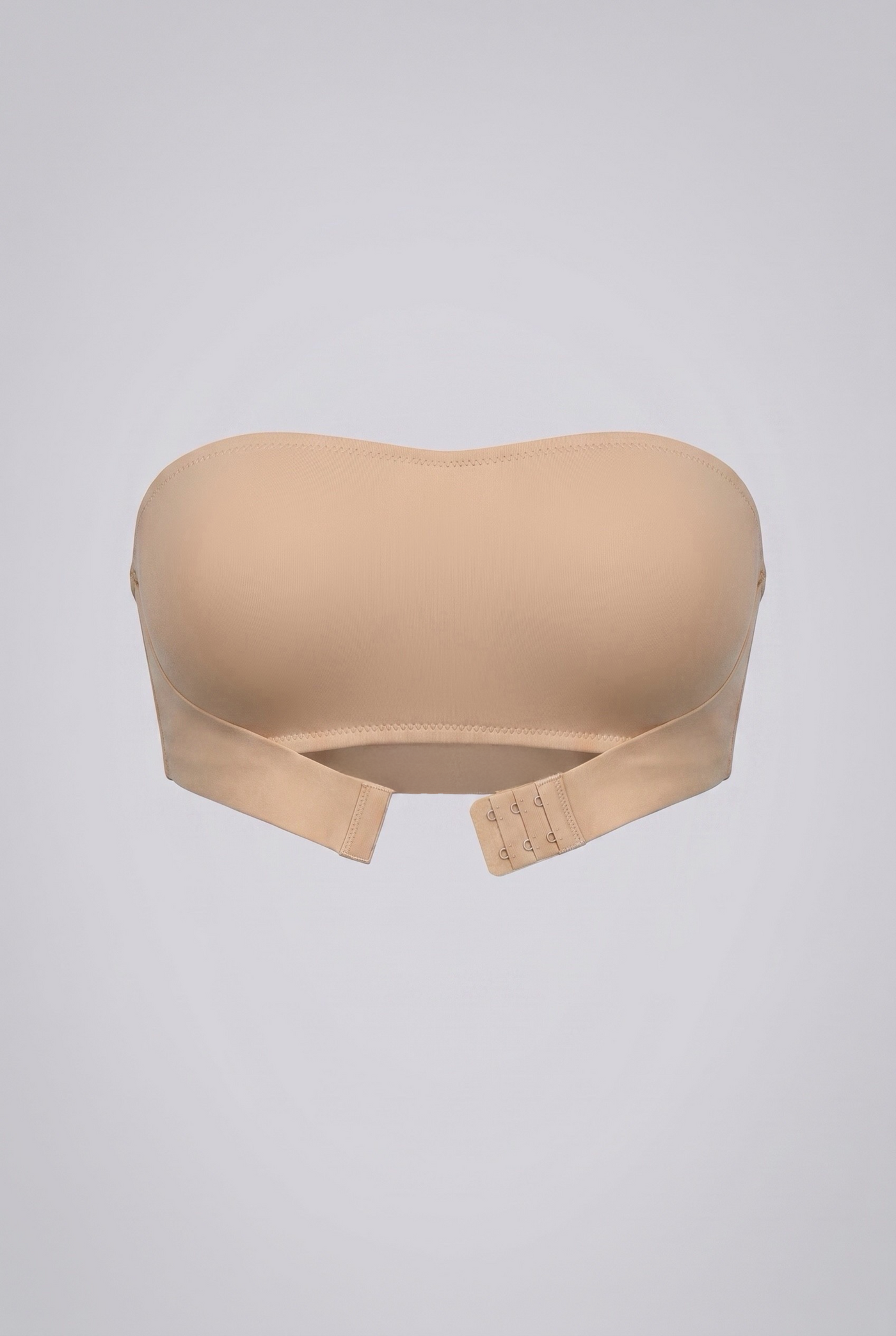 Beige strapless shapewear bra on a light gray background