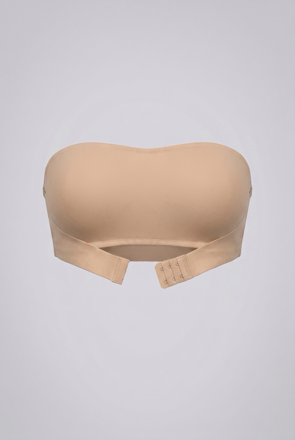 Beige strapless shapewear bra on a light gray background