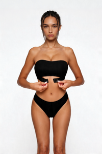 Woman wearing a black shapewear on a white background