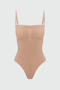 Beige shapewear bodysuit with thin straps on a light gray background