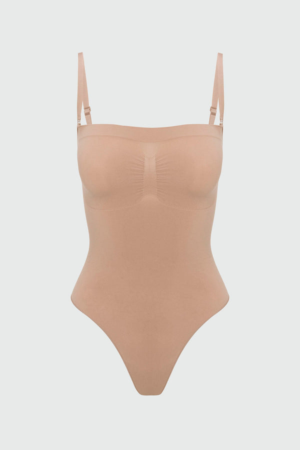 Beige shapewear bodysuit with thin straps on a light gray background