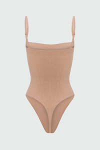 Beige shapewear bodysuit with thin straps on a light gray background