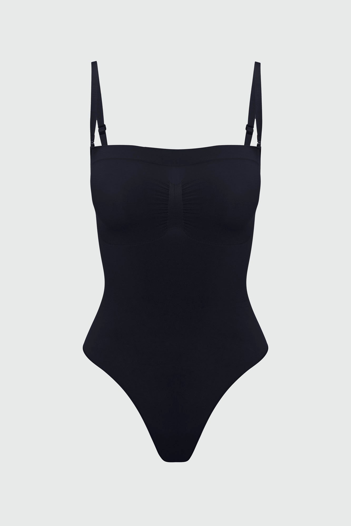 Black shapewear bodysuit with thin removable straps on a light gray background