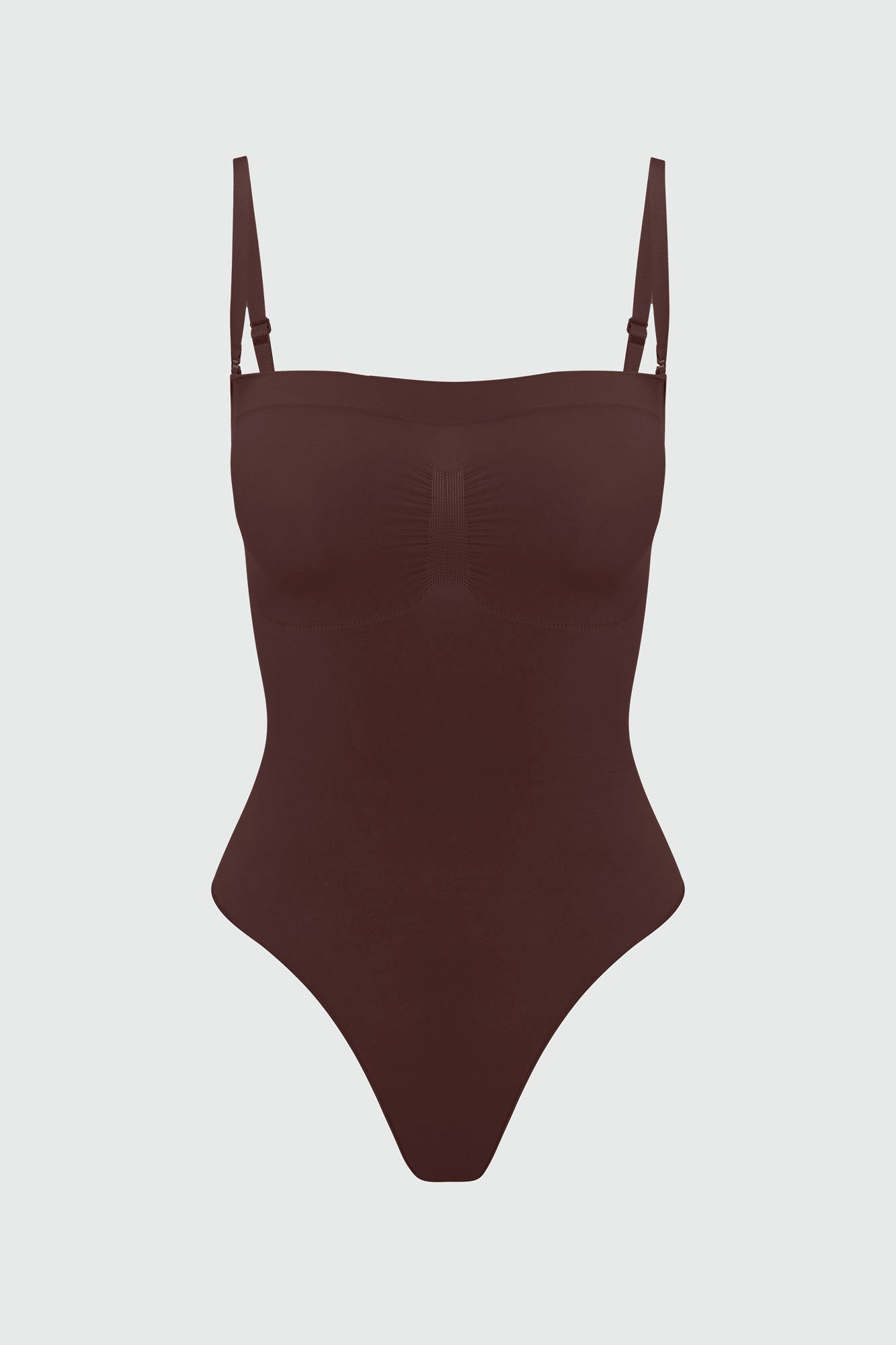 Brown shapewear bodysuit with thin straps on a light gray background