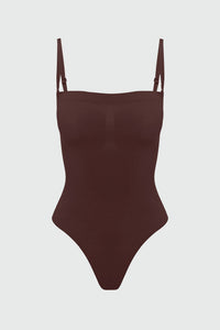 Brown shapewear bodysuit with thin straps on a light gray background