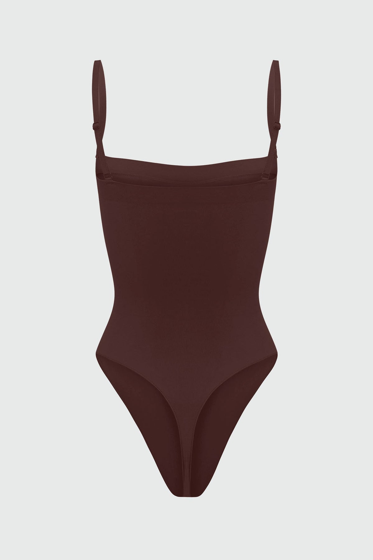 Black shapewear bodysuit with thin straps on a light gray background