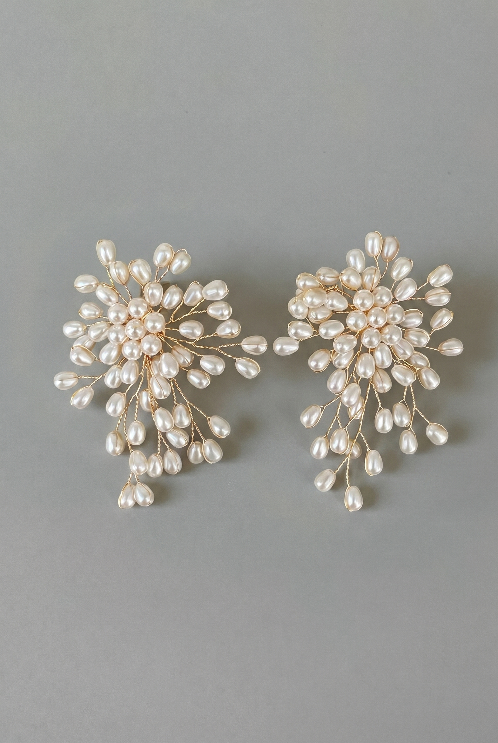 Pair of pearl earrings on a gray background